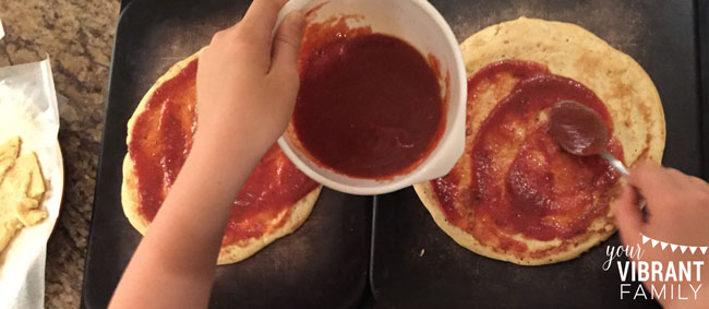 spreading-sauce-on-pizza